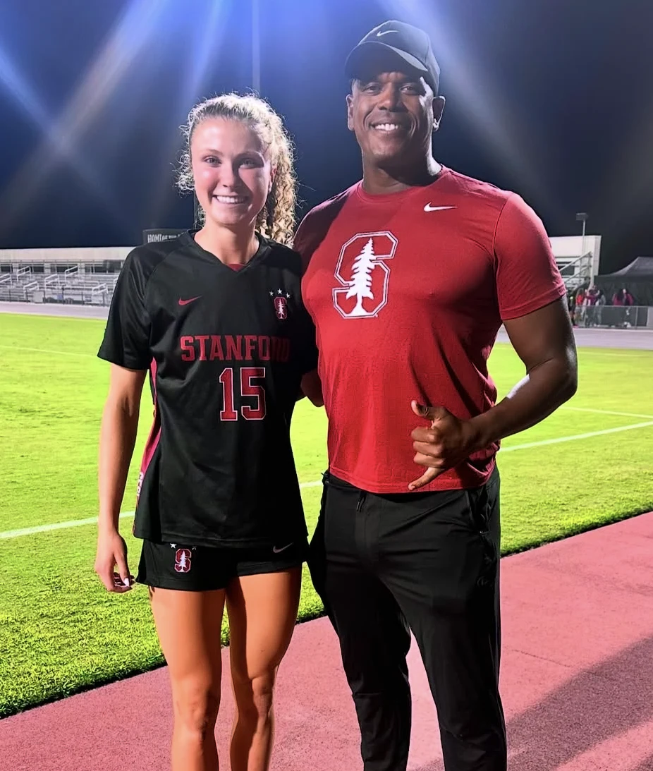 Coach Daniel with a Stanford soccer player on the field