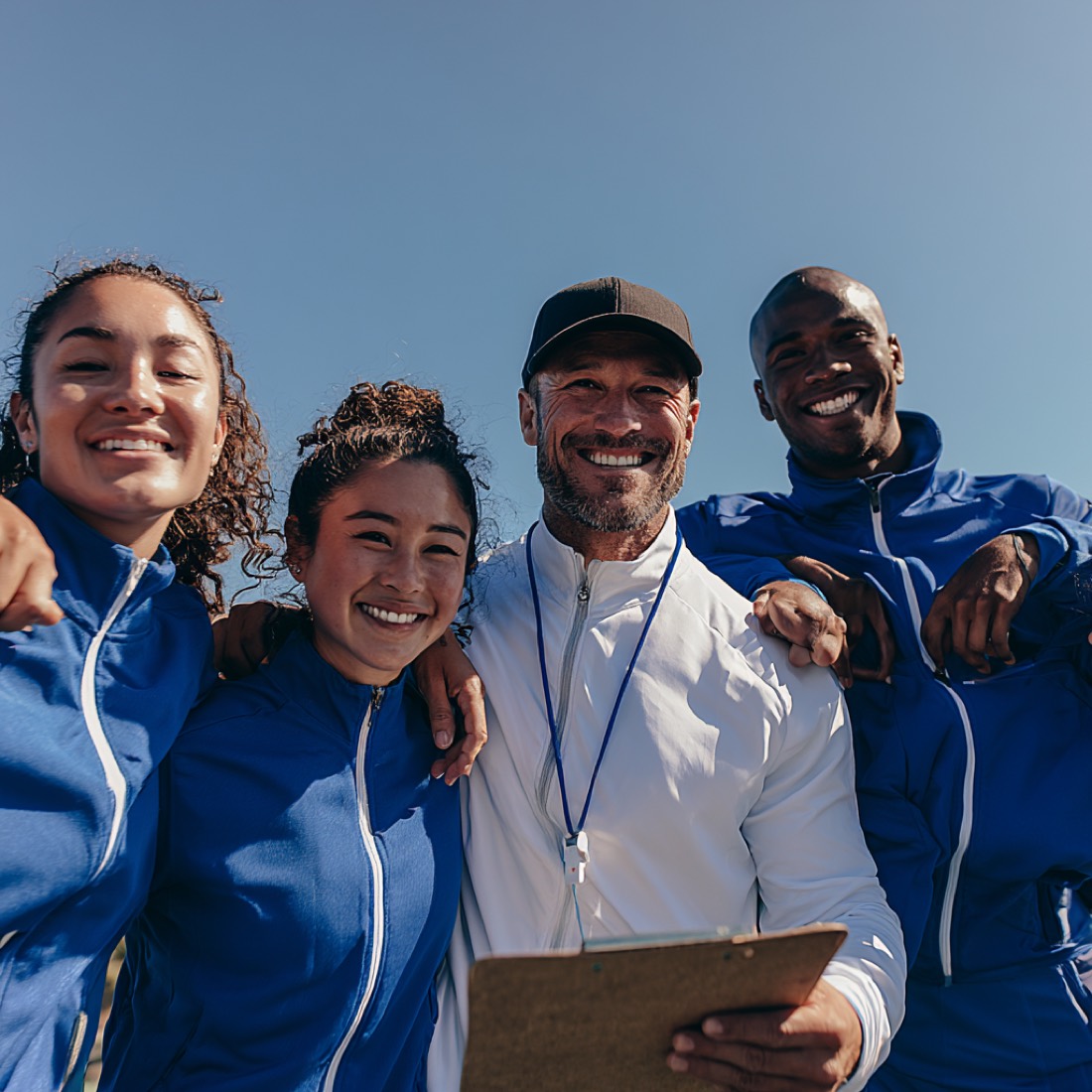 A coach with three of his players after a session